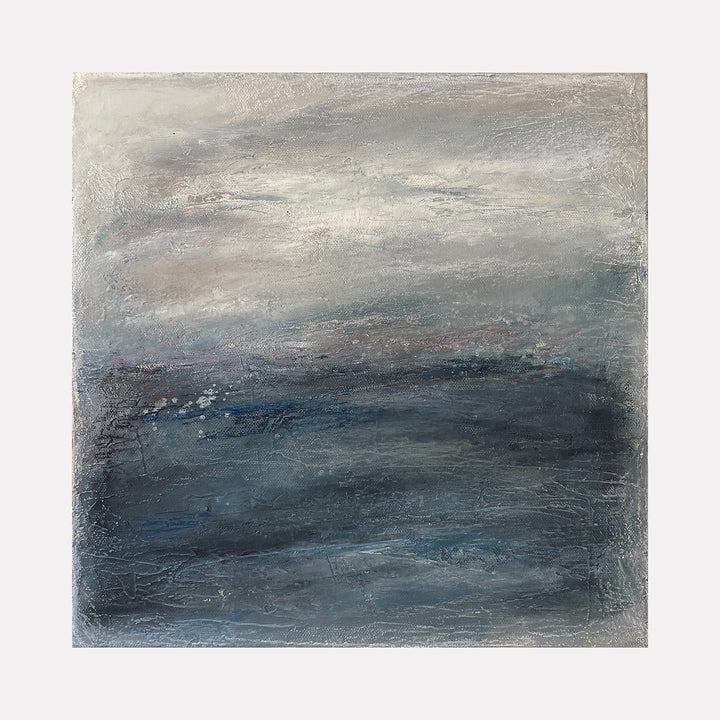 The artwork "Winter Blues I" by Xanthippe Tsalimi features an abstract composition dominated by layered shades of blue, gray, and muted white. The textured surface suggests a cold, expansive landscape under a cloudy sky. The moody palette and atmospheric depth evoke the emotional subtlety of Gerhard Richter’s abstract seascapes and the contemplative tonalism of Mark Rothko’s color fields.