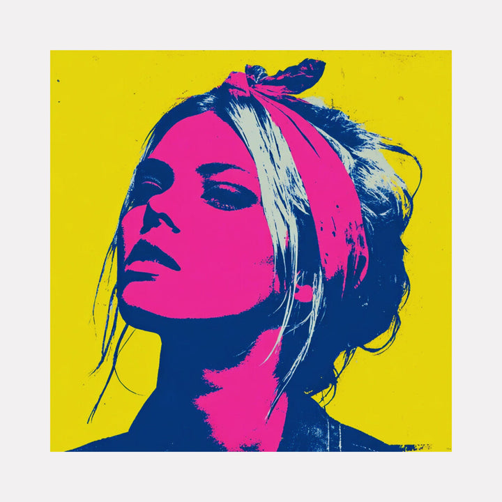 The artwork "At Her Core" by Claudia Sauter in gallery position 1 showcases a bold neon portrait of a woman with a magenta face and hair accented by a darker blue silhouette, set against a vibrant yellow background. The graphic, high-contrast style combines pop art elements reminiscent of Andy Warhol with the stark simplicity of Shepard Fairey’s iconic prints.