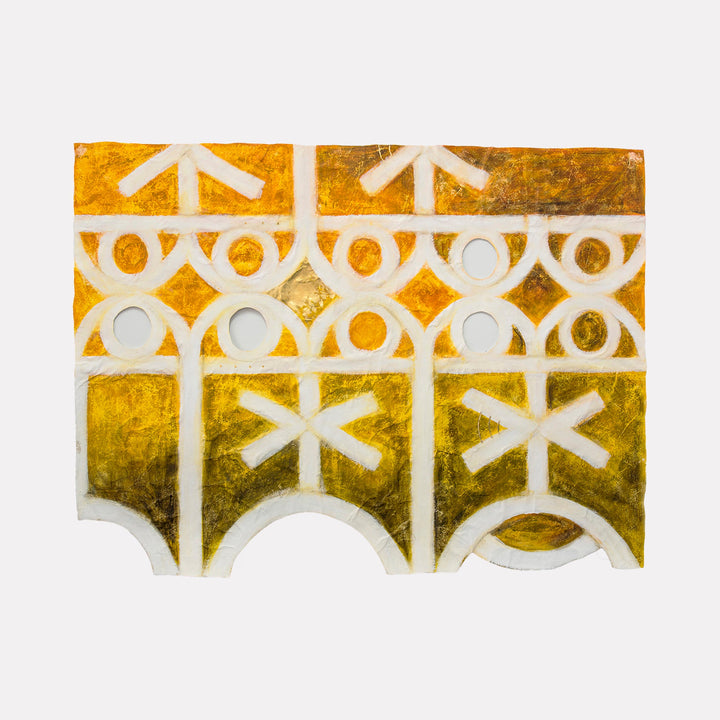 The artwork "Triclinium East" by Adina Andrus features a textured abstract sculpture with geometric patterns in warm gold and ochre hues. Bold white lines and circular cutouts create rhythmic arches and star-like shapes, evoking the playful abstraction and ornamental style reminiscent of Frank Stella and early 20th-century modernist design.