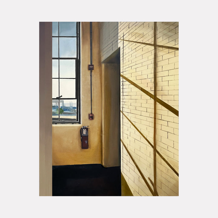 Shadows in the 5NW Hallway by Allan Gorman depicts sunlight casting sharp, angular shadows across a pale yellow brick wall beside a tall window, revealing the quiet geometry and subtle warmth of an industrial interior bathed in soft natural light with a calm, contemplative atmosphere.