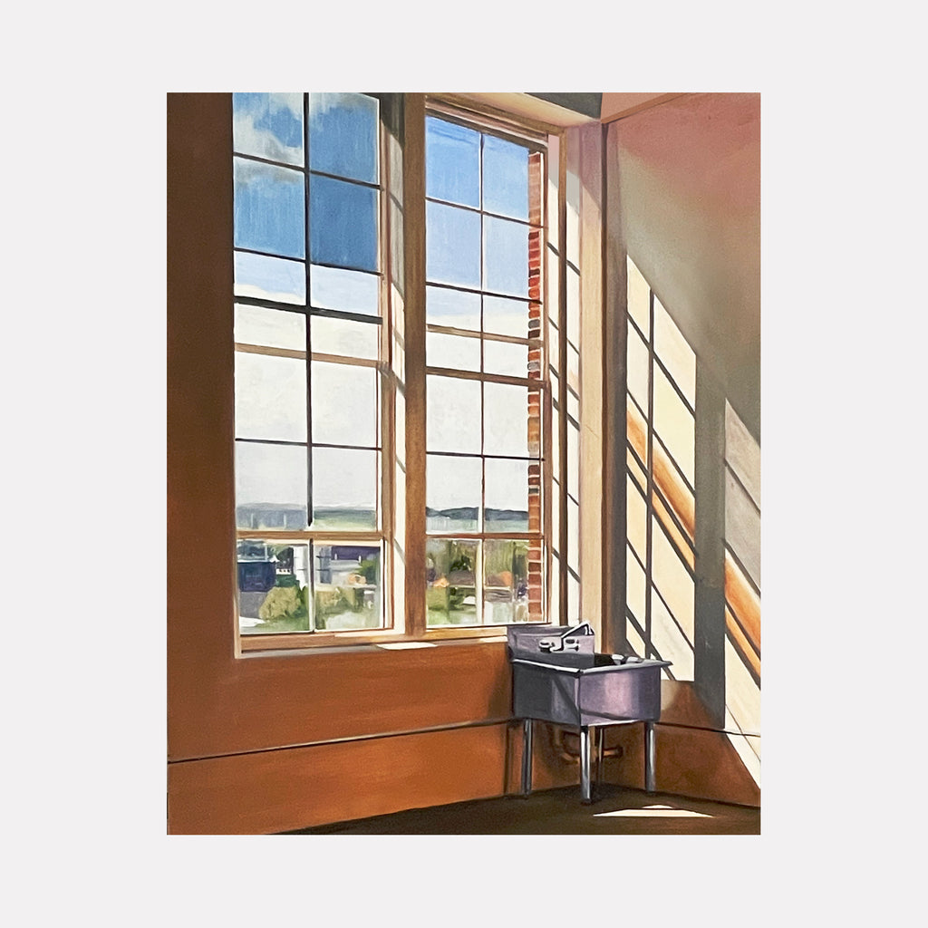 Studio Sink by Allan Gorman depicts a solitary dark sink positioned in a sunlit corner beneath tall windows. Warm light casts elongated shadows on soft peach walls, blending architectural precision with a tranquil, contemplative atmosphere that highlights the interplay between natural light and interior form.