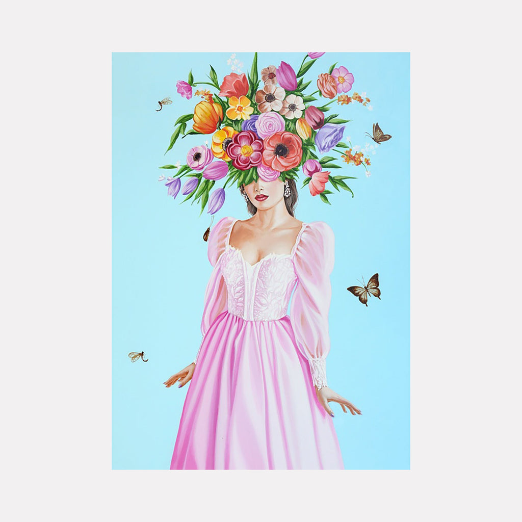 The artwork "Amusement" features a woman in a flowing pink dress with puffed sleeves, her head creatively adorned with a vibrant bouquet of various flowers in shades of orange, purple, pink, and yellow. The background is a soft blue with butterflies fluttering around, adding a whimsical, surreal quality. By Carlos Gamez de Francisco.