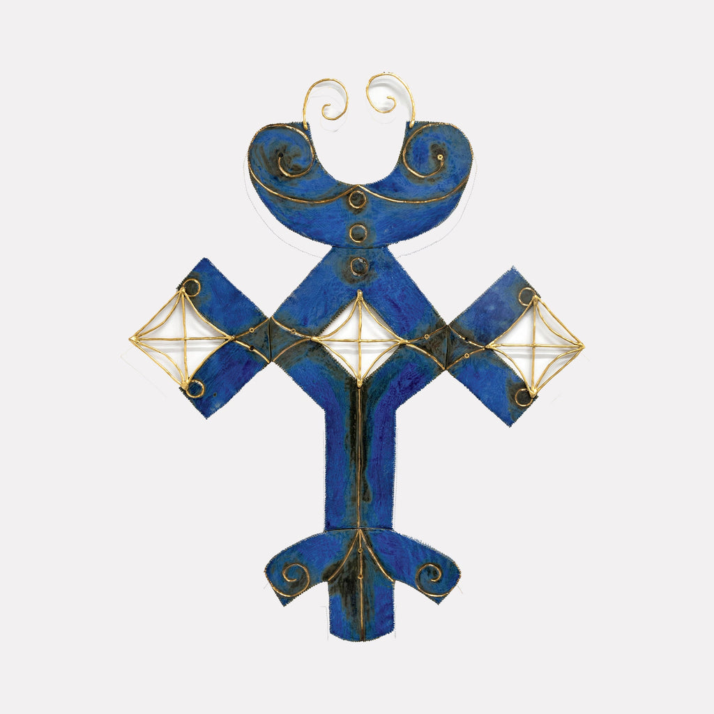 The artwork "Cannoli Wars" by Adina Andrus features a symmetrical, abstract form painted in deep blue with black accents, outlined and adorned with delicate gold wire detailing. The textured surface and geometric shapes evoke a modernist aesthetic, reminiscent of Paul Klee’s intricate abstractions and Joan Miró’s playful, biomorphic forms.