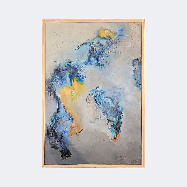 The artwork "Azure Whispers" by Janyce Erlich-Moss features a harmonious blend of soft blues, muted grays, and warm golden hues, creating an ethereal and abstract composition reminiscent of the dreamy styles of Helen Frankenthaler and Gerhard Richter. Fluid brushstrokes and textured layers evoke a sense of movement and depth within a natural wood frame.