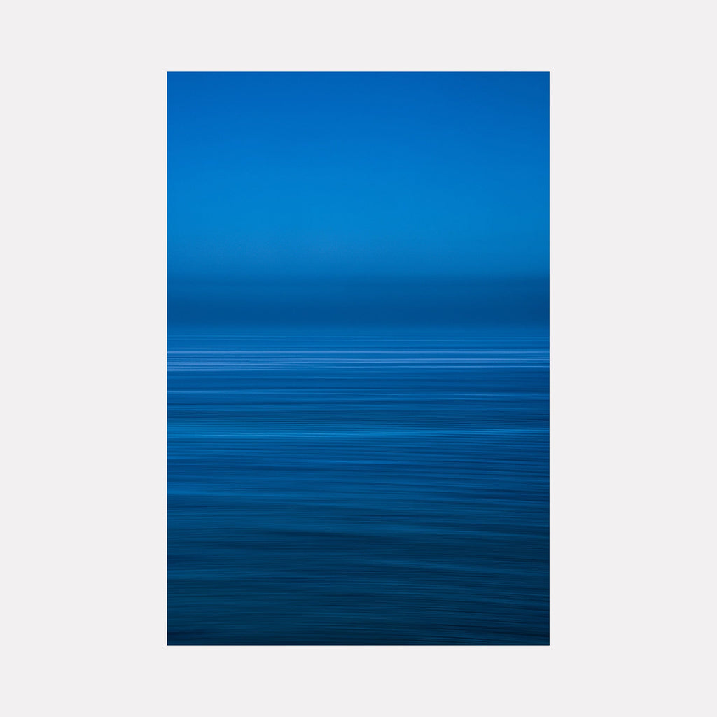 The artwork "Blue Waters" by Neil Shapiro features a serene abstract seascape dominated by deep and vibrant blues with horizontal lines suggesting gentle waves and a tranquil horizon. The smooth gradient and minimalist composition evoke a meditative quality reminiscent of Mark Rothko's color field paintings and Agnes Martin’s subtle linear abstraction.