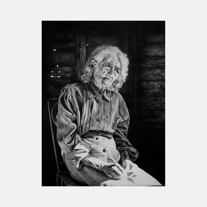 The artwork "BRUTAL LIGHT I" by Lisyanet Rodriguez features a striking black and white drawing of an elderly woman seated against a dark, textured background. The detailed, realistic rendering of her wrinkled face and hands, combined with dramatic light and shadow, evokes a poignant, introspective mood reminiscent of Chuck Closeâ€™s photorealism and the emotional depth found in KÃ¤the Kollwitzâ€™s portraits.
