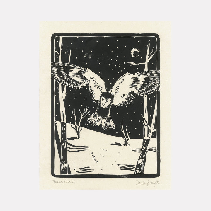 The artwork "Barn Owl" by Ashley Ranae Quick features a detailed black and white illustration of a barn owl with outstretched wings flying over a snowy landscape at night. The scene includes leafless trees, a starry sky, and a crescent moon, rendered in a bold, graphic style with strong contrasts and textured lines.