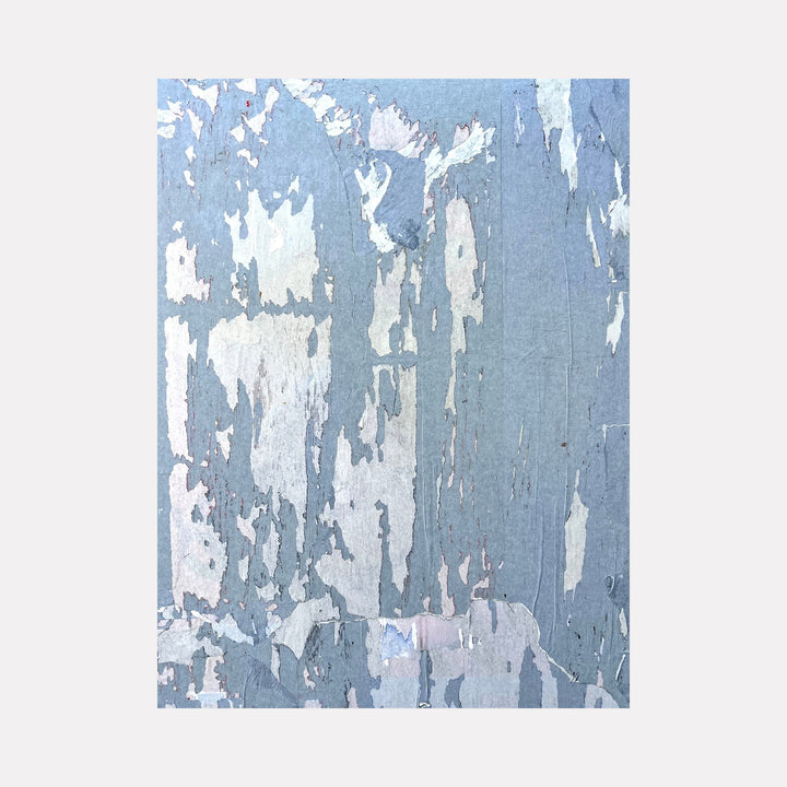 The artwork "Blue Hue 1 Shadow" by Amy Turner features an abstract composition of weathered, peeling layers in cool blues, soft grays, and muted whites. The textured, distressed surface evokes a sense of aged materiality, reminiscent of the tactile abstractions found in works by Agnes Martin and Mark Rothko’s subtle color transitions.