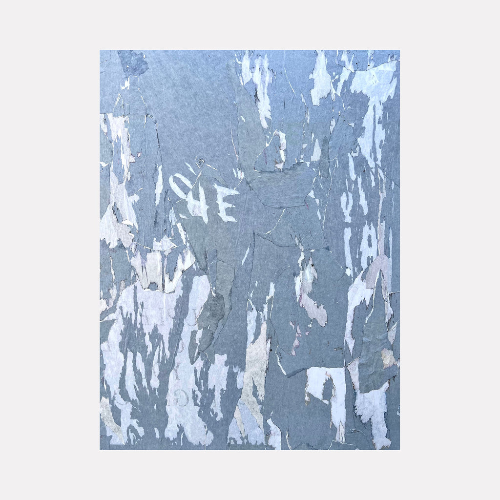 The artwork "Blue Hue 2 Shadow" by Amy Turner features an abstract collage of layered, torn paper textures in varying shades of blue, gray, and white. The composition’s fragmented, weathered surfaces evoke a sense of depth and decay, reminiscent of the textured abstraction found in works by Jean Dubuffet and Robert Rauschenberg.