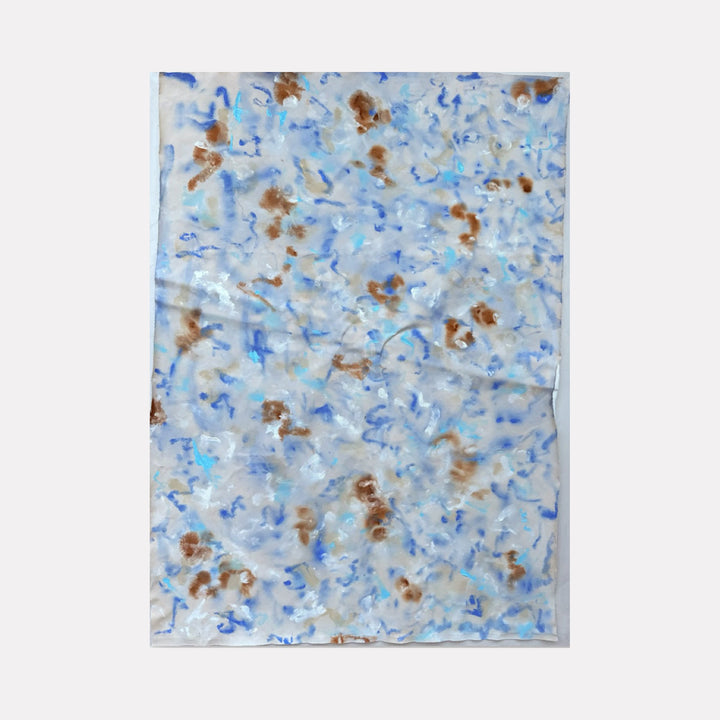 The artwork Celia by Adele Marchant features an abstract composition with soft, fluid brushstrokes in shades of blue and brown scattered across a muted white and gray background. The texture is delicate and layered, reminiscent of the ethereal qualities found in works by Helen Frankenthaler and Jackson Pollock’s drip style, blending spontaneity and subtle control.