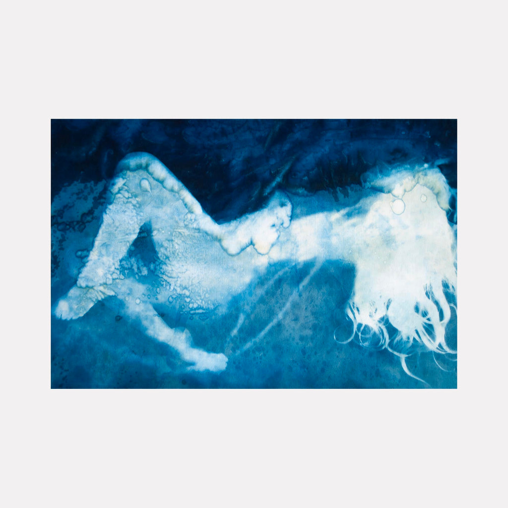 The artwork "Calliope" by Cat Welch features an abstract, ethereal figure reclining against a deep blue, textured background. The flowing white silhouette with delicate, wispy lines evokes a dreamlike quality reminiscent of Henri Matisse’s cut-outs and Andy Warhol’s screen prints, blending fluid shapes and rich pigment in a contemporary, artistic style.