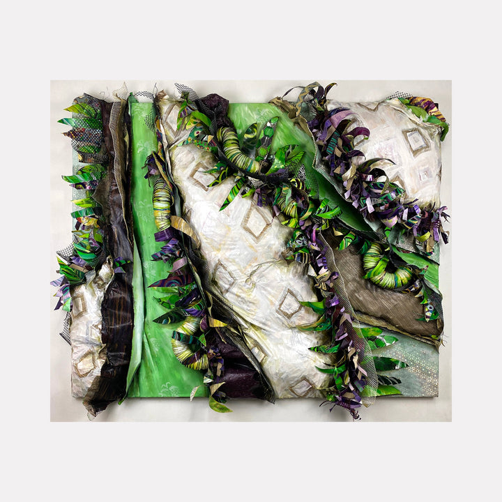 The artwork "Crafty Collaboration 9" by Christina Massey features layered, textured fabric with prominent green, white, and purple hues, incorporating curling and folded elements that create a dynamic, three-dimensional effect. The abstract composition evokes the tactile qualities seen in works by artists like Christo and Jeanne-Claude.