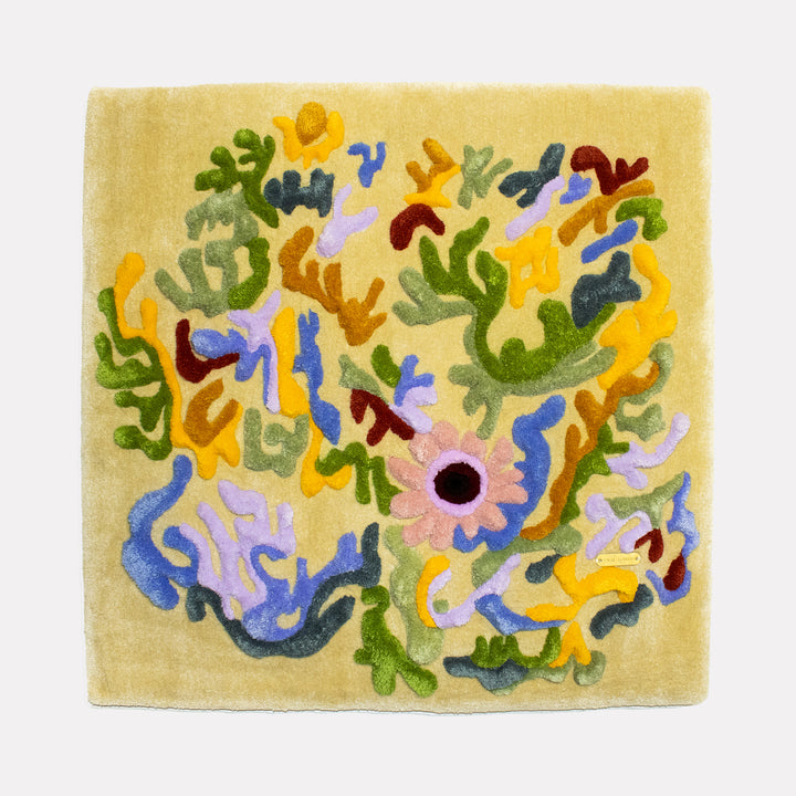 The Coral Flowers by Abigail Henthorne depicts a lively arrangement of abstract floral and organic shapes in soft pastel colors like pink, purple, yellow, green, and blue, set against a warm beige background, creating a whimsical, textured composition that evokes a delicate yet vibrant natural scene.