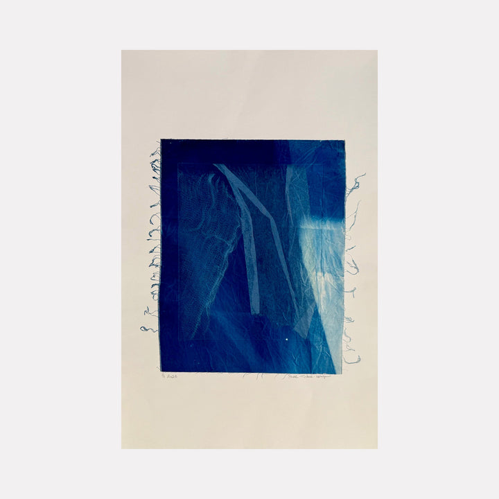 The artwork "Cyanotype Veil 2" features a rich blue cyanotype print with delicate, translucent veil-like textures and abstract linear shapes layered over a light background. The piece highlights intricate fabric details and soft gradients of blue in an ethereal, modern style. Created by Starr Tucker-Ortega.