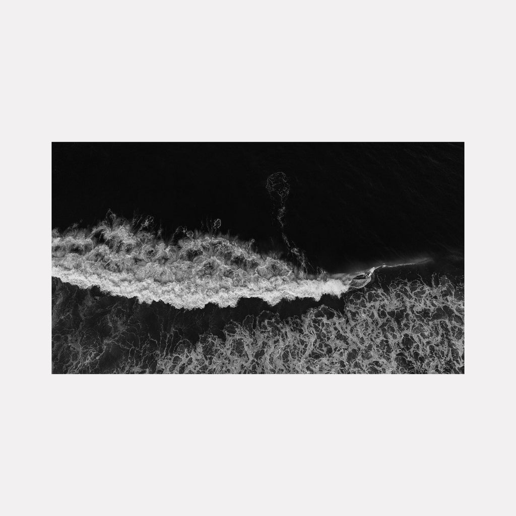 The artwork "Control" by Dennis Maida features an aerial black and white view of ocean waves breaking with intricate details in the foam's texture and flow. The high contrast and abstract composition evoke styles similar to Ansel Adams' photography and minimalistic monochrome art. Dennis Maida.