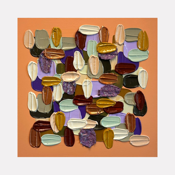 Dreamy Dollop by Shiri Phillips displays a vibrant collection of thick, textured paint dabs in rich earth tones, mustard yellow, muted purples, and soft creams against a warm peach backdrop, creating a tactile, playful composition that invites closer inspection and adds a lively, contemporary touch to any setting.