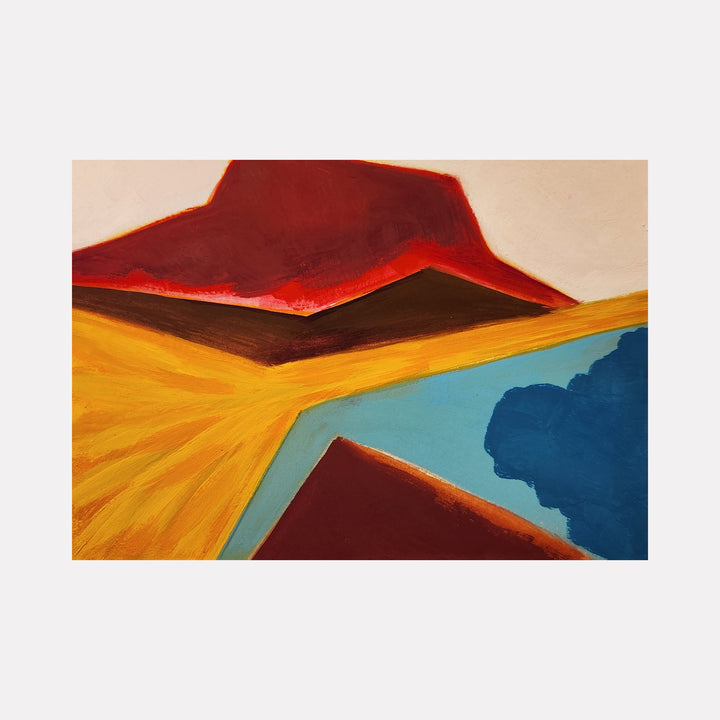 The artwork 'Erupt' features bold geometric landscapes with a deep red mountain peak against a golden yellow plain, contrasted by turquoise blue waters. The composition uses vibrant acrylic gouache to create dramatic angular forms and striking color transitions, painted on cotton paper mounted on wood panel by Joanie Flickinger.