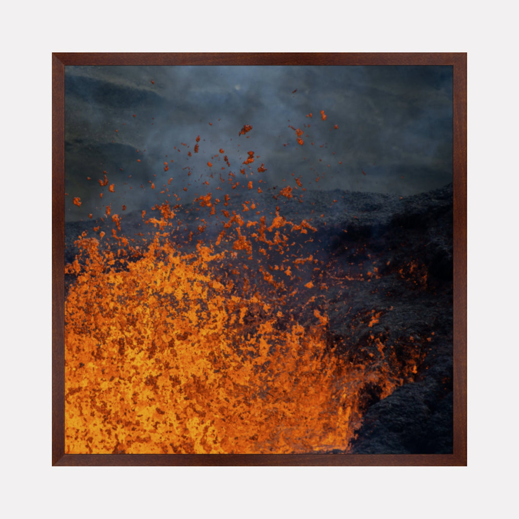 Eruption by Kyle Murphy captures an intense volcanic scene with molten lava bursting upward against a smoky, darkened sky. The vivid orange and red hues contrast sharply with the surrounding blackened rock, evoking the raw power and dynamic energy of nature’s fiery forces.