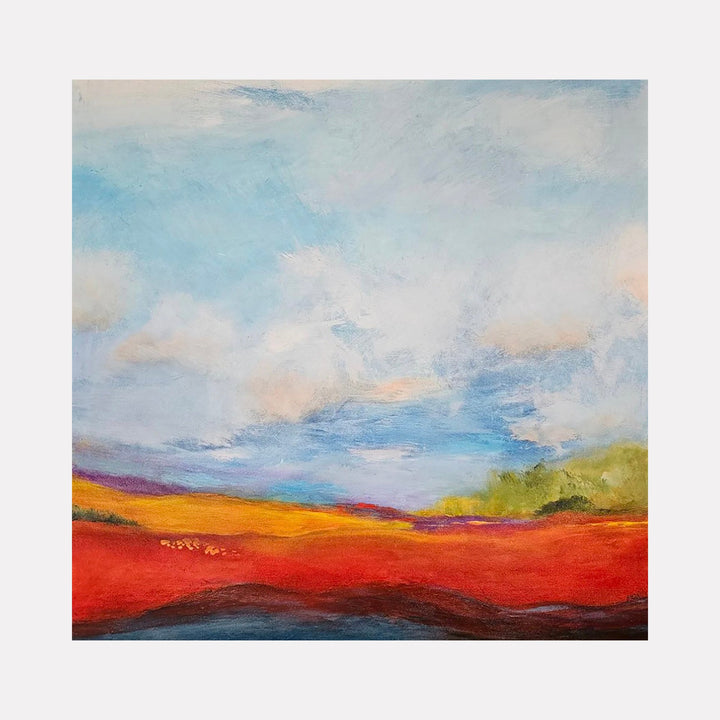 The artwork Etherial Expanse by Janyce Erlich-Moss features a vivid abstract landscape with bold red, orange, and yellow fields under a vast sky of soft blues and whites. The textured brushstrokes and atmospheric blending evoke the style of Mark Rothko and Helen Frankenthaler, merging color field painting with impressionistic skies.