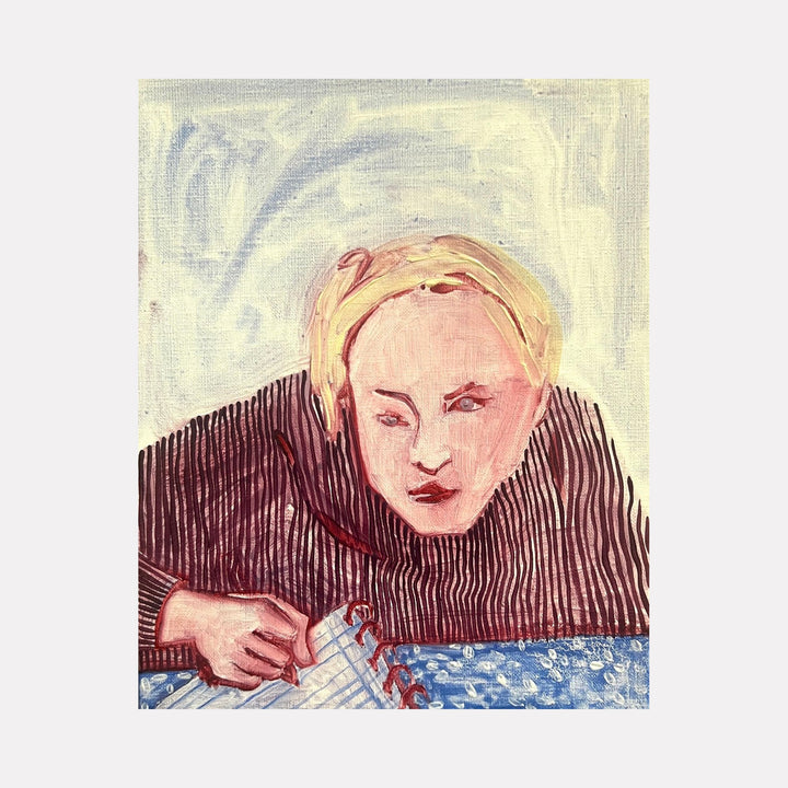 The artwork 'Eve Doing Homework After Eating an Apple from the Garden' by Monica Carrier depicts a figure leaning over a blue patterned surface, painted in expressive brushstrokes. The composition features muted cream backgrounds with pink flesh tones, and distinctive vertical striped textures in dark burgundy. The oil on linen painting captures an intimate study in concentration, measuring 10x8 inches.