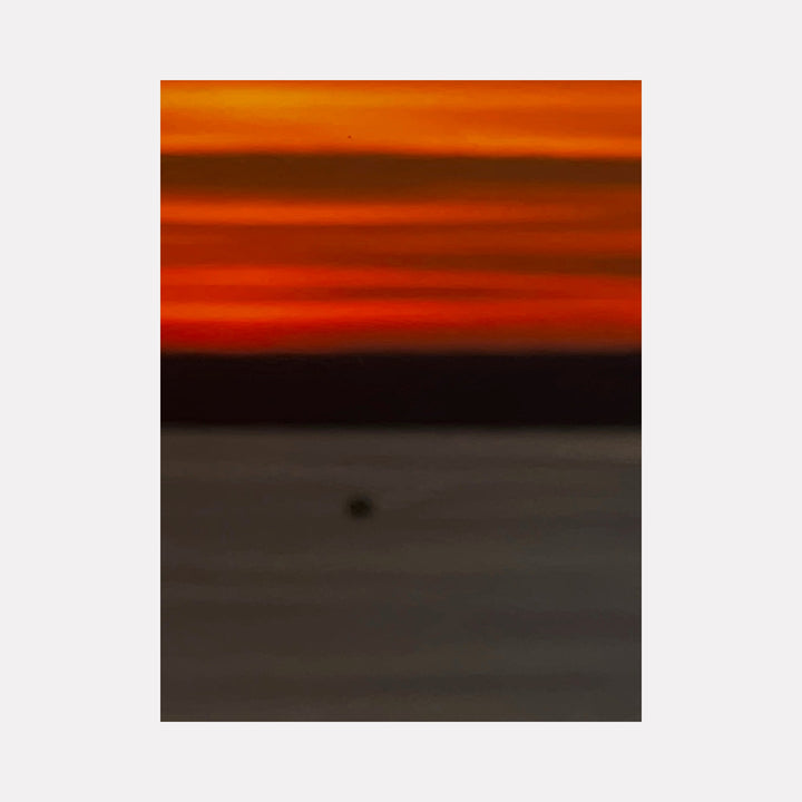 The artwork "Fire & Ice 2" by Starr Tucker-Ortega features a vivid abstract landscape with bold horizontal bands of fiery orange and red blending into dark, muted shades of black and gray, evoking a dramatic contrast reminiscent of fire and ice. The smooth gradient and minimalistic style highlight the interplay of warm and cool tones.