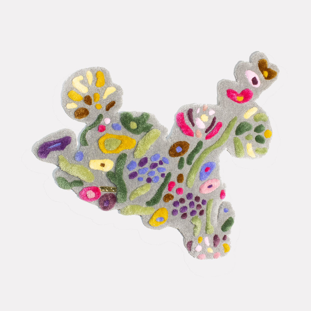 The artwork "Flower Arrangement" by Abigail Henthorne features an abstract cluster of organic shapes with soft textures in muted greens, purples, yellows, pinks, and browns on a neutral background. The flowing, biomorphic forms evoke the playful abstraction of Joan Miró and the tactile realism found in the works of Jean Dubuffet.