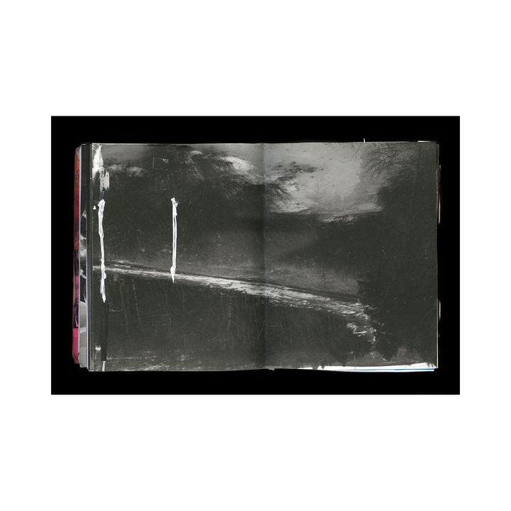 The artwork "For Bill" features an open sketchbook with predominantly dark, textured black and gray brushstrokes creating a moody, abstract landscape. White vertical streaks and a diagonal line add contrast and depth to the composition. The piece emphasizes texture and minimalist expression by Kelly McGovern.
