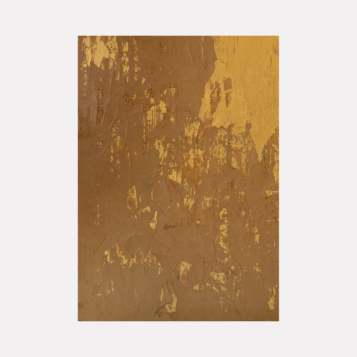 The artwork "Gold Mine" by Amy Turner features an abstract textured surface with rich golden and earthy brown tones. The composition displays layered patches and rough brushstrokes, creating a weathered, metallic effect with a tactile, rugged finish. The dynamic interplay of light and shadow enhances the depth and richness of the piece. Amy Turner.