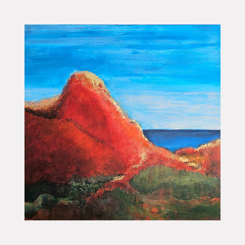 Golden Mountain by Janyce Erlich-Moss is a Curina art piece capturing a vivid red mountain peak under a bright blue sky, with textured earthy tones and greenery in the foreground, evoking a serene natural landscape imbued with warmth and depth.