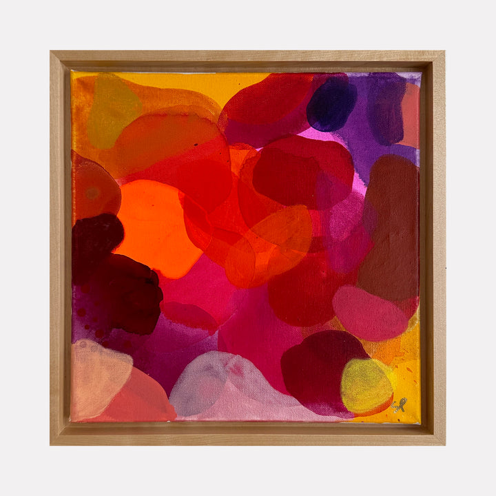 Hearts Desire 2 by Shiri Phillips showcases an energetic blend of overlapping organic shapes in vivid reds, oranges, purples, and soft pinks. The translucent layers create a warm, vibrant composition that radiates a playful yet sophisticated energy, inviting the viewer to explore its rich interplay of color and form.