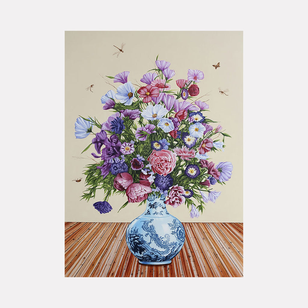 The artwork "Idealism and Perfection II" features a detailed bouquet of vibrant flowers in various shades of purple, pink, and white arranged in a blue and white porcelain vase with intricate patterns, set against a neutral background with subtle insects flying around. The composition highlights texture and realism. By Carlos Gamez de Francisco.