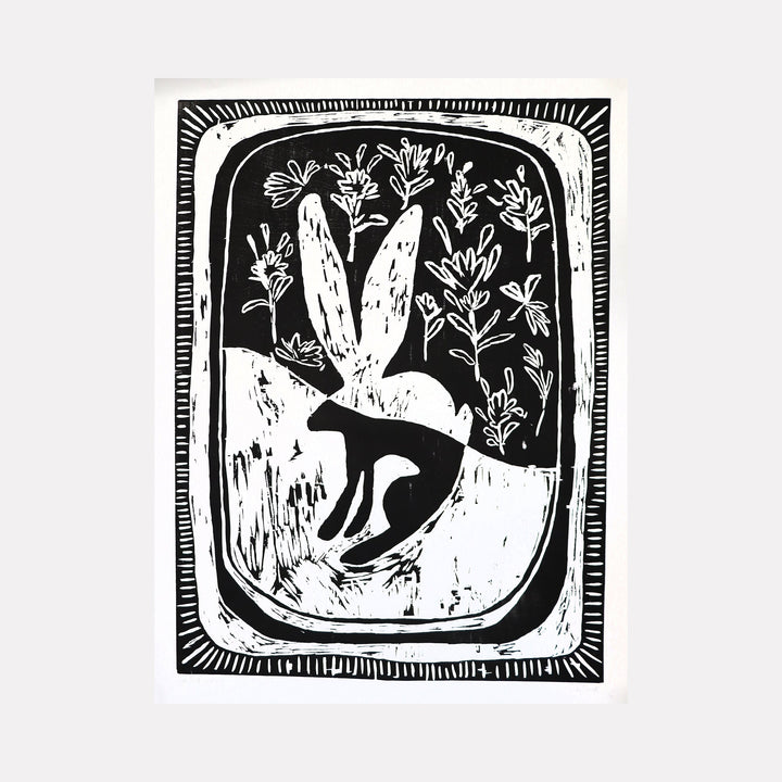 The artwork "In Good Company" features a black and white abstract design with organic shapes resembling a rabbit or hare surrounded by delicate floral elements and textured patterns. The composition is framed by a hand-drawn border with rhythmic line details. The piece combines bold contrasts and natural motifs. By Ashley Ranae Quick.