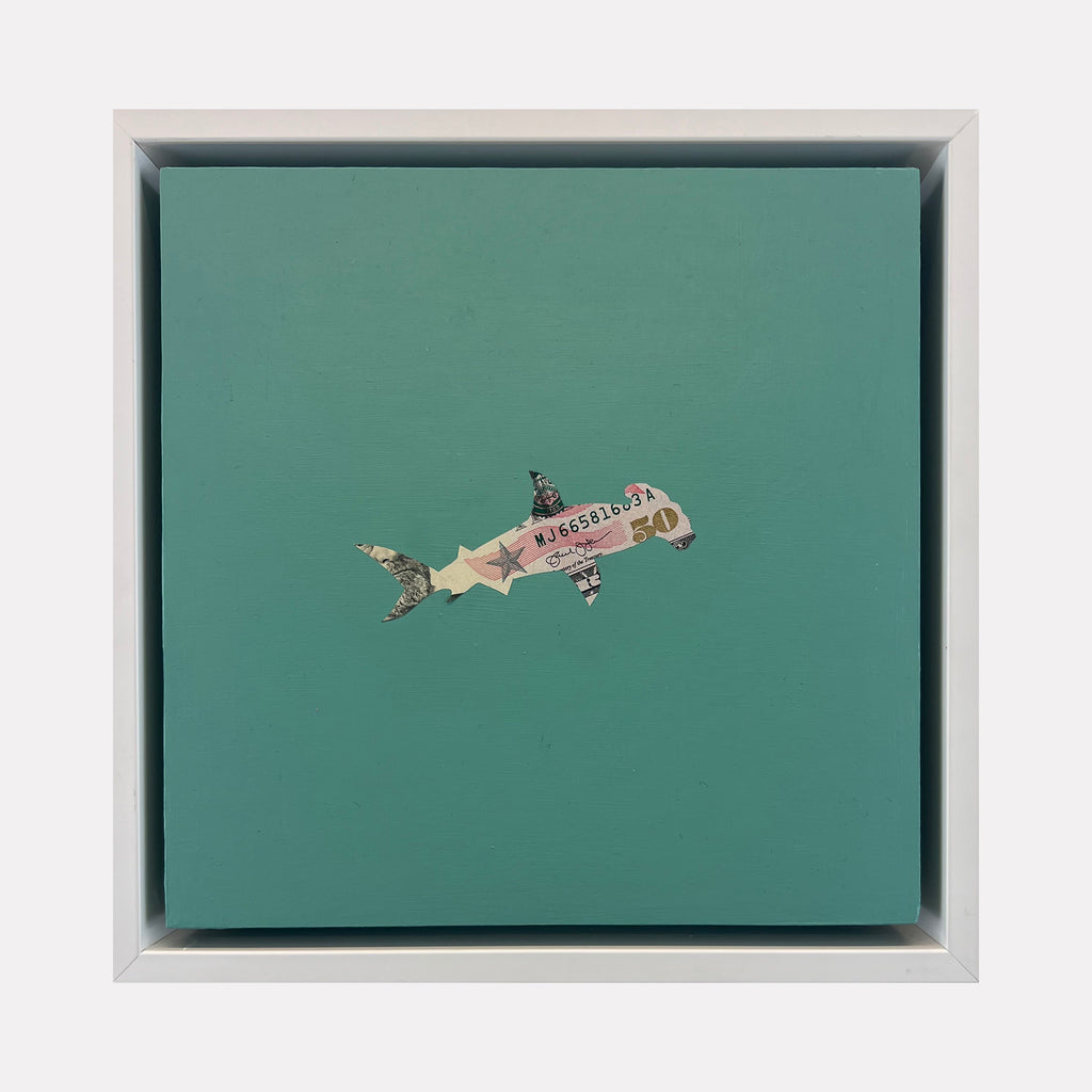 The artwork "Spirit Messengers, Hammerhead" by Jacki Davis features a hammerhead shark crafted from US currency and acrylic on a teal wood panel measuring 8 by 8 inches. The shark combines textured currency details with a smooth painted background, blending mixed media elements into a minimalist, modern design.