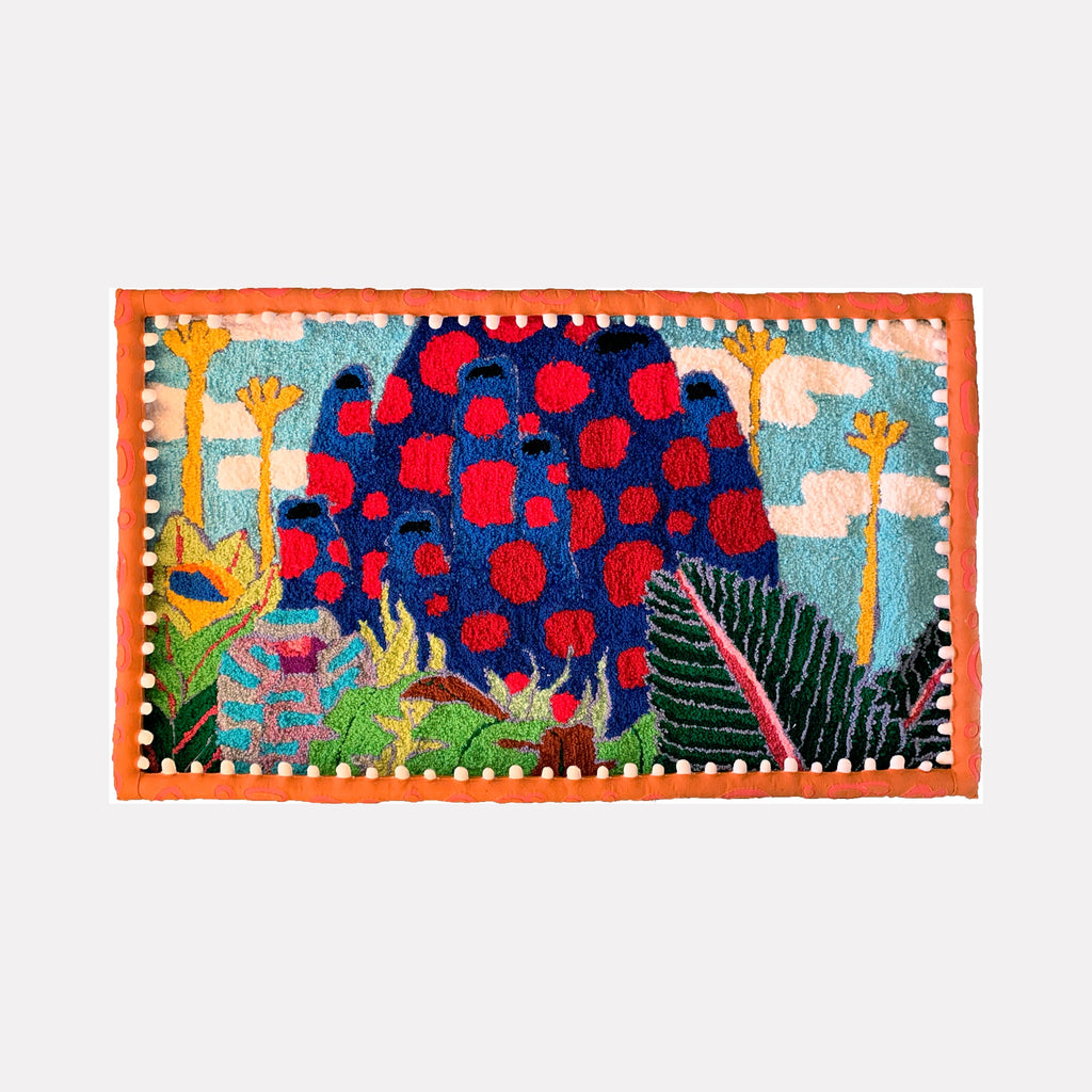 The artwork "Harvest" by James Hsieh features a vibrant textile composition with bold, organic shapes in deep blues and reds, punctuated by bright orange and lush green foliage against a light blue sky with stylized clouds. The rich textures and playful patterning evoke the dynamic, nature-inspired abstraction reminiscent of Henri Matisse’s cut-outs and Yayoi Kusama’s polka dots.