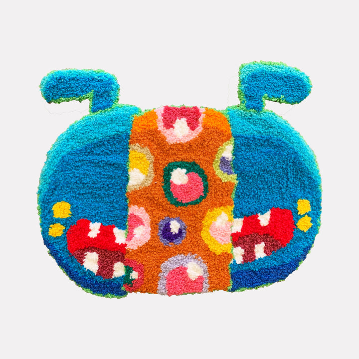 The artwork "What Is Essential Is Invisible To The Eye" by James Hsieh features a vibrant, textured abstract creature with bold patches of turquoise, orange, red, and yellow. Its playful, tufted loops and circular motifs recall the whimsical surrealism and bright color palettes of artists like Takashi Murakami and Yayoi Kusama.