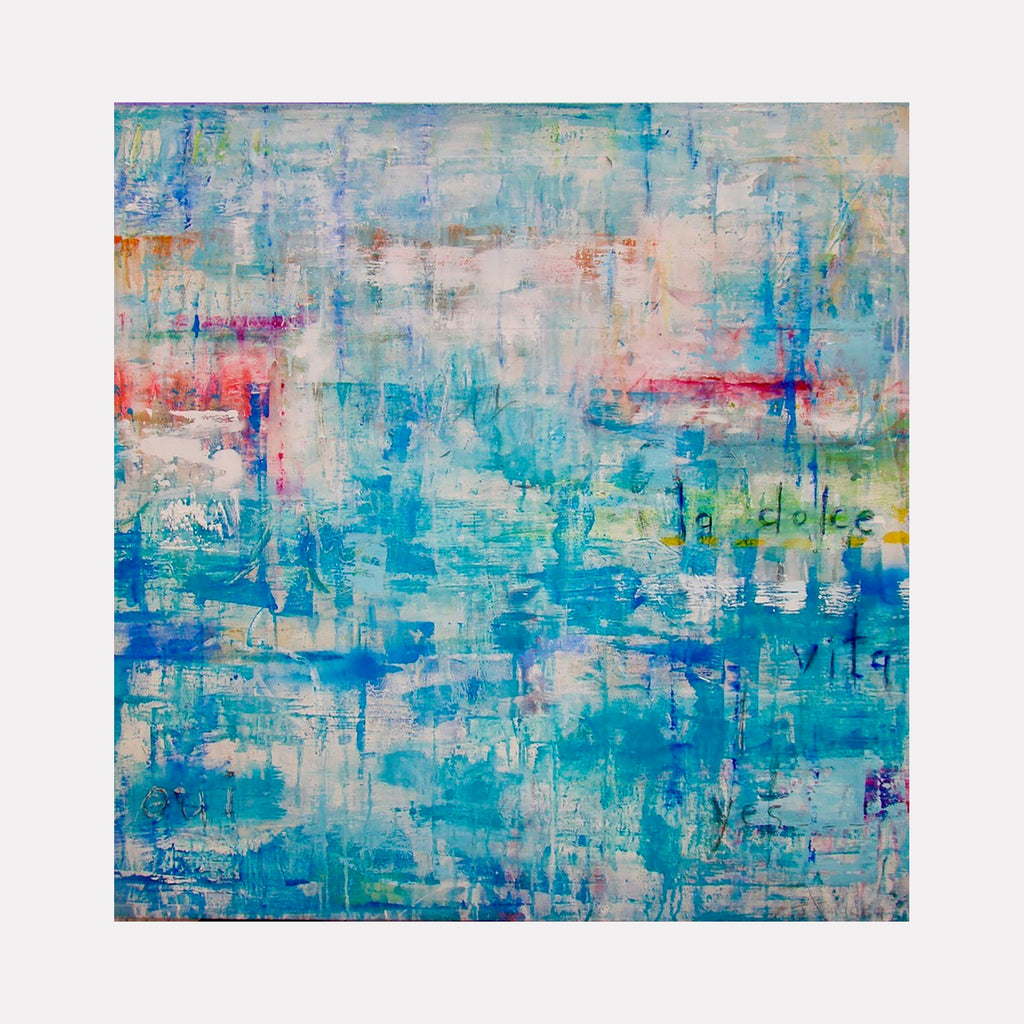 The artwork "LA DOLCE VITA" features a layered abstract composition with dominant shades of blue, turquoise, and hints of pink, orange, and white. The textured brushstrokes create a sense of depth and movement, with subtle text elements faintly visible in the background. This vibrant, modern piece expresses a dreamy, fluid aesthetic by Amadea Bailey.