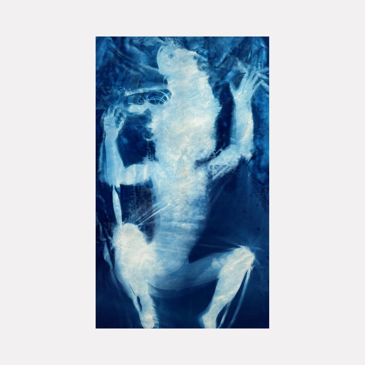The artwork "Launch" by Cat Welch presents a ghostly, translucent figure in soft white and various shades of blue, evoking a cyanotype photographic style reminiscent of early photographic pioneers like Anna Atkins. The ethereal textures and abstract, almost skeletal forms create a haunting, surreal atmosphere that blends modern abstraction with classic photographic techniques.
