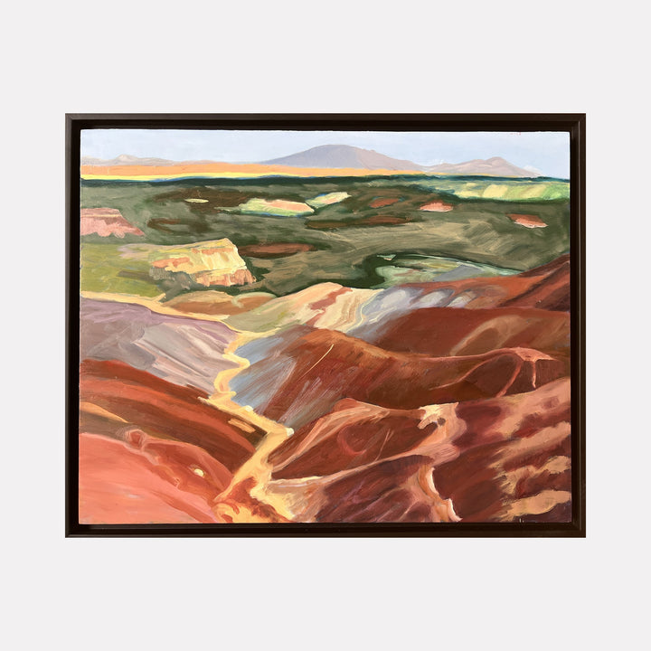 The artwork Long Valley by Connie Falk depicts a sweeping landscape with layered, earthy tones of red, brown, green, and soft yellows, capturing the textures and undulating forms of a valley. The style echoes the expressive brushwork and color palette reminiscent of early 20th-century American landscape painters like Georgia O’Keeffe.
