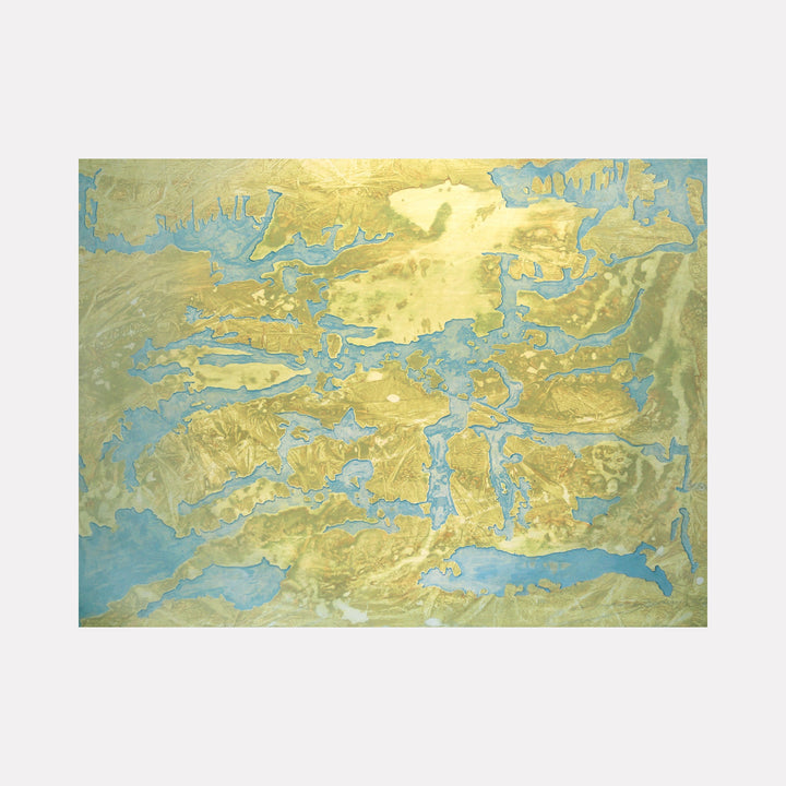 The artwork "Martians About to Land on Disappearing Island" by Marlene Struss features an abstract landscape with shimmering gold and muted blue hues, creating an ethereal map-like texture that suggests a vanishing island surrounded by water. The composition evokes a sense of mystery and otherworldly exploration. Marlene Struss.