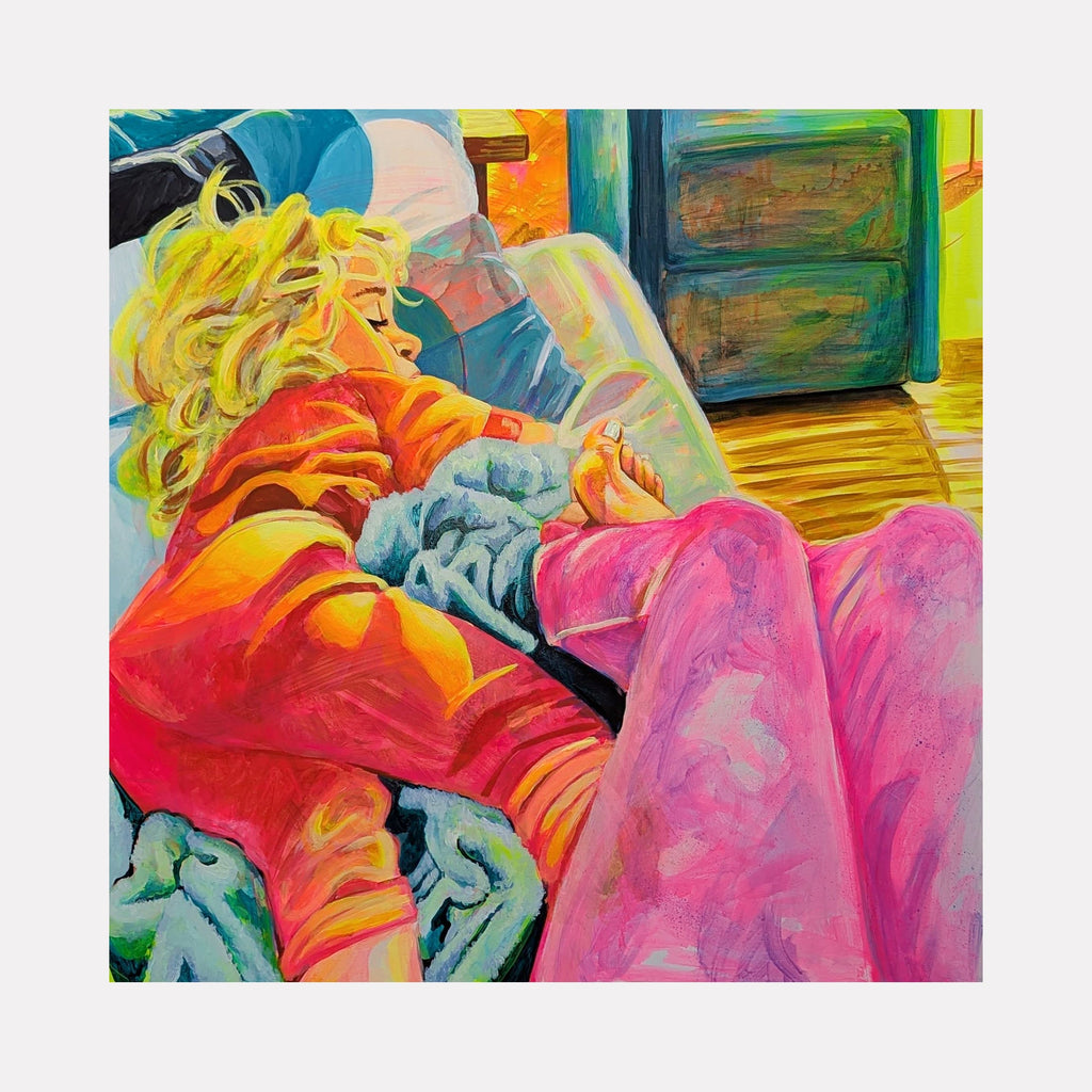 The artwork "Sunday Morning" by Mary Younkin depicts a cozy, intimate scene with bold, vibrant colors and dynamic brushstrokes reminiscent of modern expressionism. Featuring a figure with blonde hair in orange and pink tones, layered textures evoke warmth and comfort, with a style echoing the emotional depth found in works by artists like Edward Hopper and David Hockney.