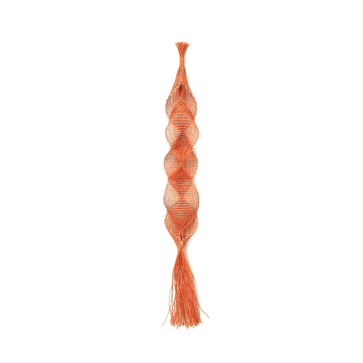 The artwork "Lily Pendant" by Morgan Hale features an elongated, organic form composed of delicate, interwoven orange threads creating a textured, sculptural netting. Its intricate layering and fluid shapes evoke the tactile quality reminiscent of Alexander Calder's mobiles with a modern artisanal twist, blending craftsmanship and contemporary design.