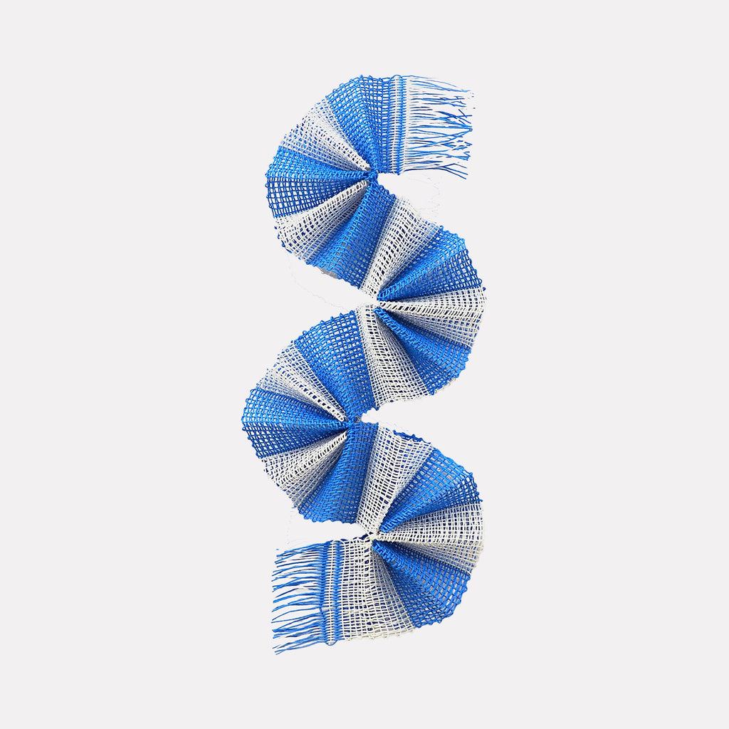 The artwork "Sky Curve" by Morgan Hale features a spiraling textile sculpture composed of alternating blue and white woven sections, creating a dynamic, curved form reminiscent of movements in modern abstract art. The textured fabric and fringe details evoke the intricate weaving styles found in works inspired by artists like Anni Albers and the geometric abstraction of Sonia Delaunay.