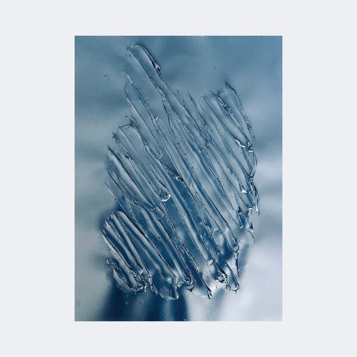 The artwork "Nuances of Depth 6" by Albion Vu features a textured abstract composition with translucent, layered strokes resembling ice or glass shards arranged vertically against a smooth, muted blue-gray background. The style evokes the minimalism and subtle texture exploration reminiscent of Gerhard Richter's abstract works, blending modern depth with simplicity.