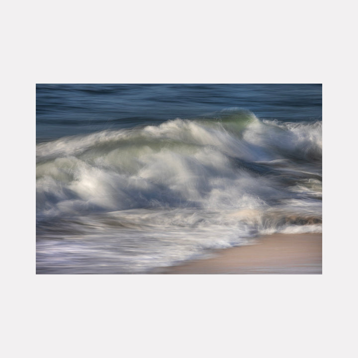 The artwork "Ocean Waves" by Sandi Daniel features a serene seascape capturing dynamic waves in motion with soft white foam and deep blue water. The textured layers and blurred brushstroke effect evoke the fluidity of nature, reminiscent of the atmospheric qualities found in works by J.M.W. Turner and contemporary impressionist landscape photography.