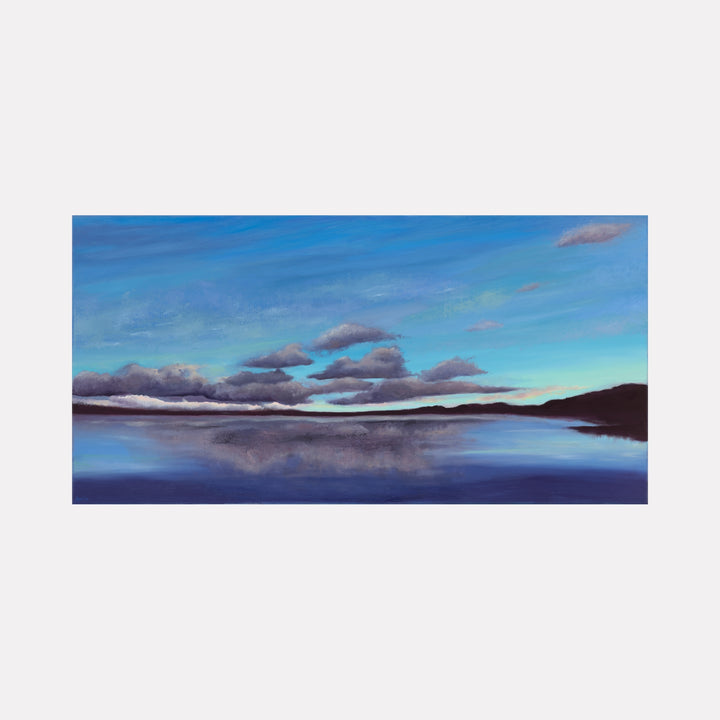 Other Worldly Glow by Nadia Parsons depicts a tranquil lake under a vast sky with soft clouds and subtle light transitions, blending serene blues and purples to evoke a peaceful, ethereal atmosphere in this captivating landscape art piece.