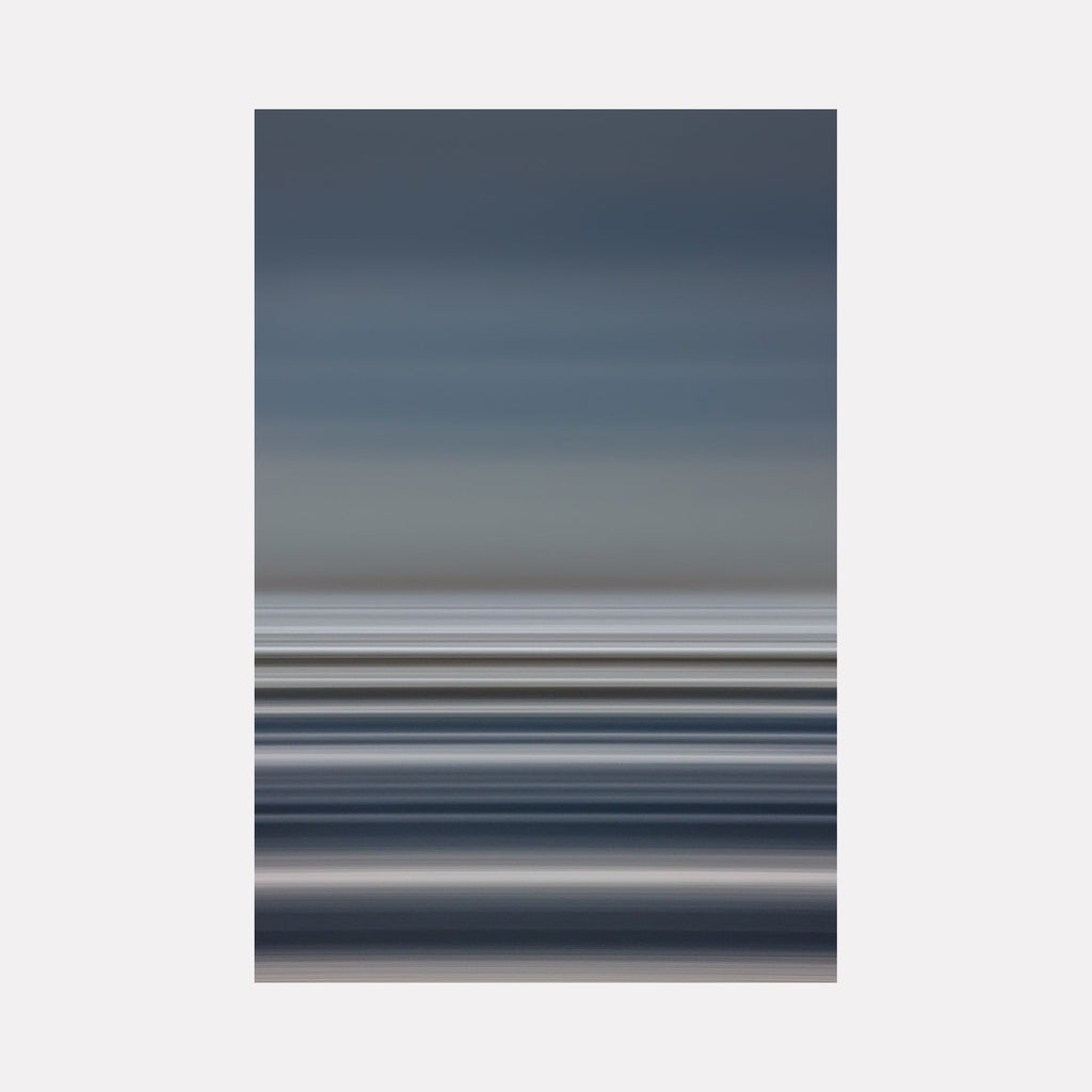 The artwork Pacific Sun Belts by Neil Shapiro features horizontal bands of muted blues, grays, and soft whites, creating a serene and minimalistic abstract landscape. The smooth gradients and layered textures evoke the calming atmosphere of dusk or dawn, reminiscent of Mark Rothko’s color field paintings and Agnes Martin’s subtle linear abstractions.