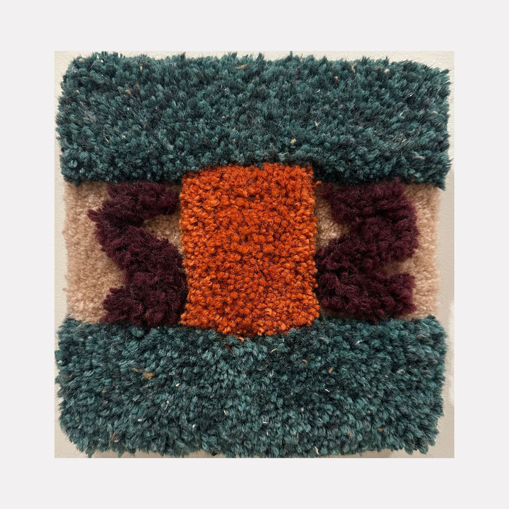 The artwork "Ponte (Bridge)" by Ana Maria Farina features a textured, tufted design with a central rectangular orange section flanked by dark purple abstract shapes, all bordered by deep teal green on the top and bottom, and beige background areas. The piece highlights a tactile, woven material with vivid colors and geometric forms. Ana Maria Farina