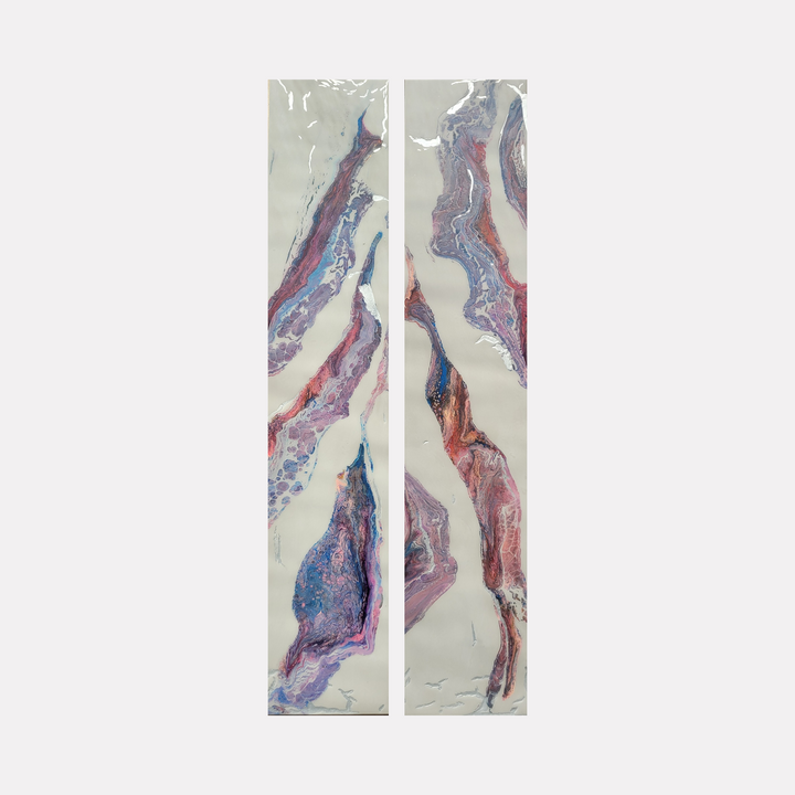 Purple Rain 1 & 2 by Swann Freslon presents a serene diptych of fluid, organic forms in shades of purple, soft blue, and warm pinks against a pale, glossy background. The composition evokes a delicate, natural flow and textured depth, suggesting a graceful, abstract interplay of color and movement.