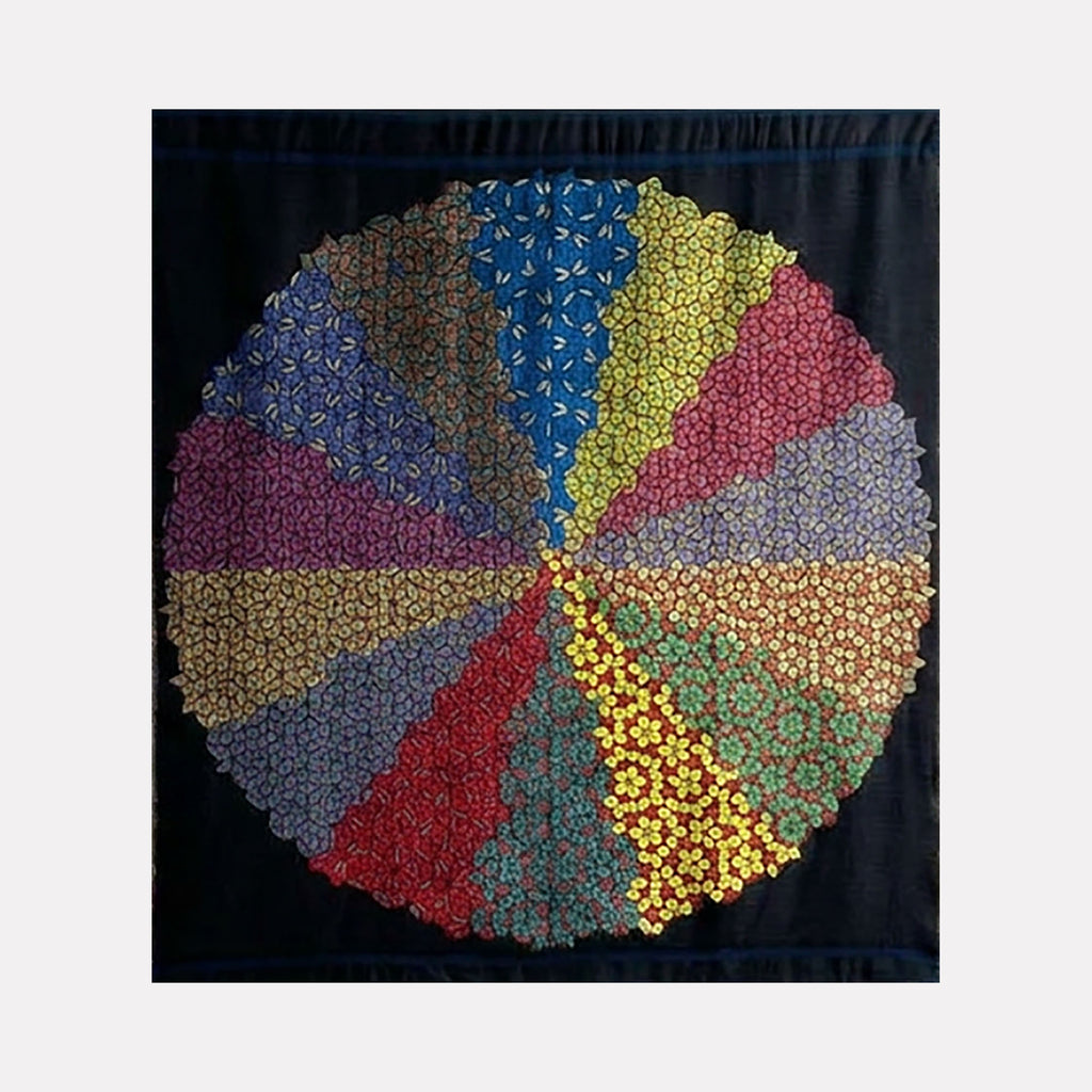 Quasicrystals (#R2) by Victoria Manganiello is a Curina art piece featuring a circular collage of intricate floral patterns in varied colors, arranged in segmented wedges against a dark background, creating a harmonious blend of symmetry and detailed organic design.
