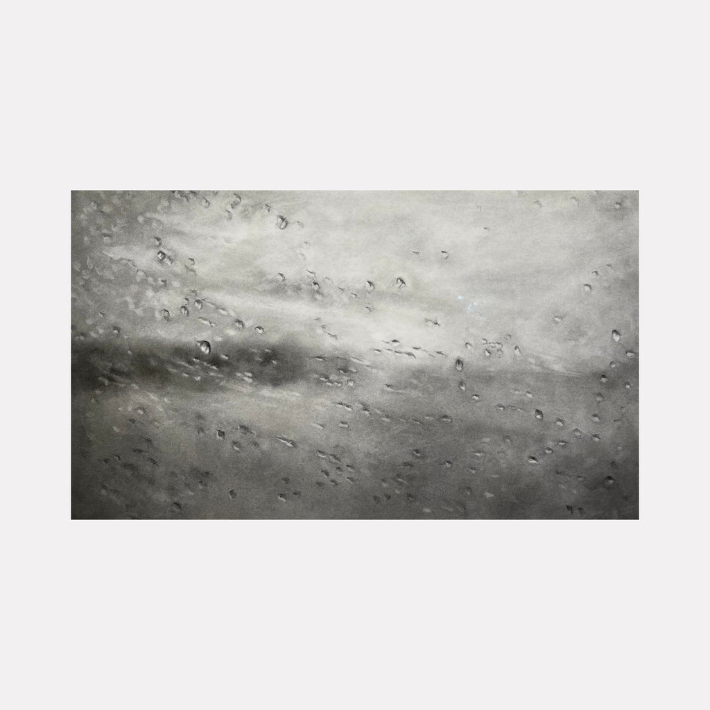 The artwork "Rain on the Susquehanna" by Regina Miele features a moody grayscale scene with textured droplets scattered across a blurred background, evoking a rainy atmosphere. The composition and subtle tonal shifts recall the impressionistic softness of works by Claude Monet, blending abstraction with natural elements to create a contemplative effect.